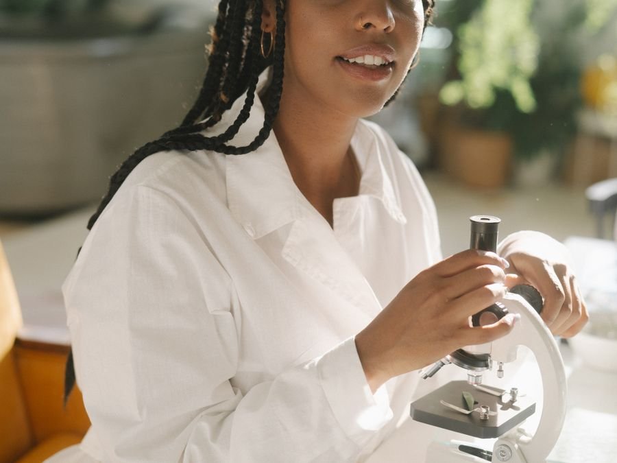 Laboratory scientist with a microscope